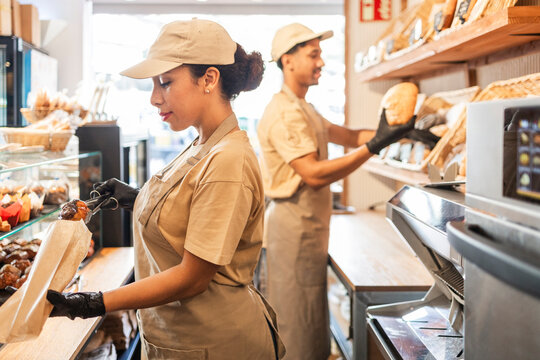 Bakery workers organizing bread and pastries
