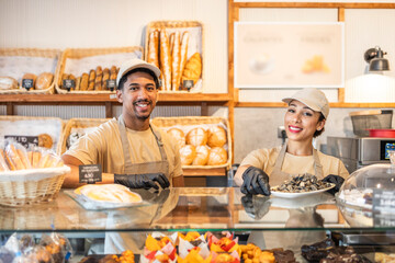 Smiling bakery staff serving pastries and bread