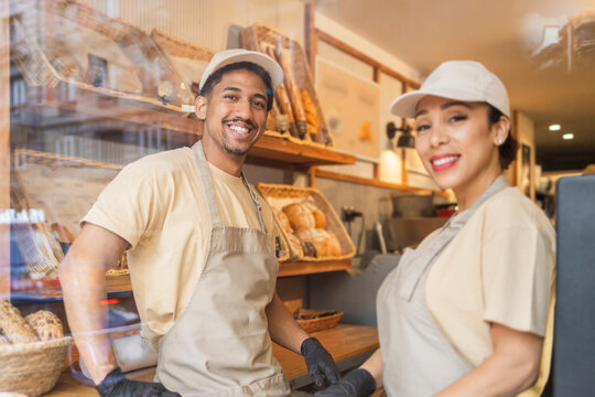 Smiling workers in a cozy bakery setting