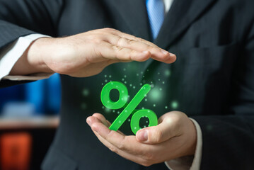 A businessman keeps his green interest in his hands. Attractive interest rates on deposits and favorable loan terms. Financial benefits and banking opportunities. Investment, personal finance and loan