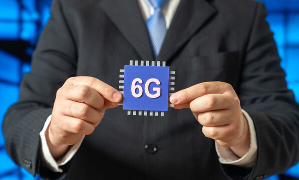 The new 6G microchip in the hands of a businessman. An innovative communication standard. Internet of Things. Ultra fast connectivity and network evolution. Telecom, IoT infrastructure development