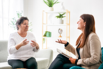 Portrait of a woman with her senior patient in her office in clinic