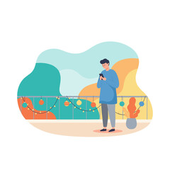 Young man using a smartphone on a festive balcony illustrating digital life and connectivity