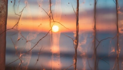 Fototapeta premium Delicate sheer organza curtain with a veined pattern filters the warm light of a beautiful sunset over the calm ocean, creating a dreamy and serene atmosphere