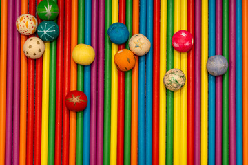 Full frame texture of colorful wooden sticks with scattered beads. Rainbow colors background concept