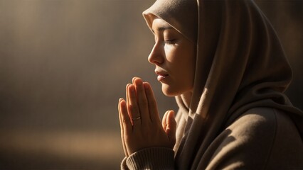 Muslim woman in hijab praying with eyes closed. Side profile portrait showing faith, spirituality, and devotion with copy space
