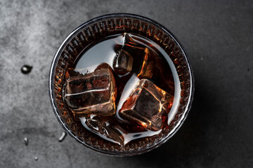 Whiskey with Ice Cubes in Glass &ndash; Top View on Dark Background