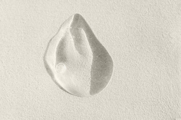 Close-up of a transparent gel smear with bubbles. Cosmetic products. A drop of serum or essence on...