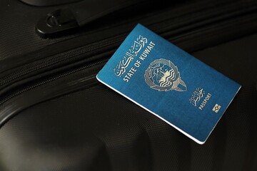 Kuwaiti passport on travel luggage close up. The concept of travel and vacation