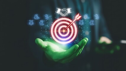Businessman holding digital target with arrow, currency symbols, and handshake icon, representing financial goal achievement, online business, investment success and global business strategy. Handshak