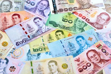 Thai baht currency money bills. The current banknotes lies on table in big amount close up