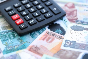 Egyptian pound currency money bills and calculator close up. The concept of taxation and money count