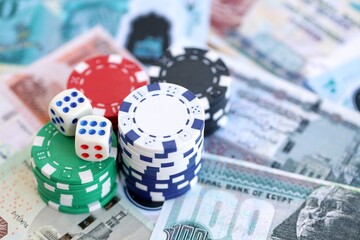 Egyptian pound currency money bills and casino chips with dices. The concept of gambling and poker casino games