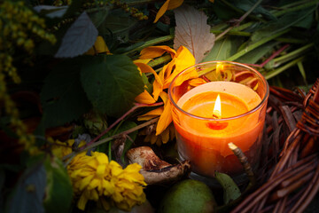 Warm glow enhances peaceful evening, Rustic scene illuminated by gentle amber flames atmosphere, Basket with candles and flowers creates calming seasonal setting