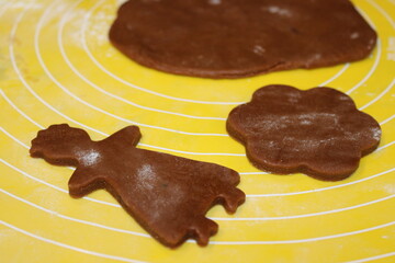Baking cookies and preparing dough shapes in a kitchen setting during the late afternoon