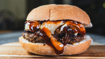 Delicious cheese burger with homemade sauces, presented on a beautiful wooden board. Juicy, flavorful, and perfect for gourmet fast food promotions and menus.