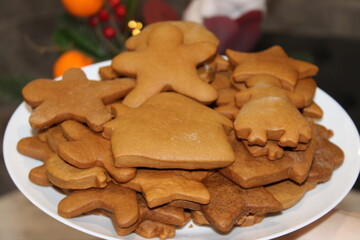 Freshly baked cookies arranged on a white plate ready for holiday celebrations with friends and family in a cozy kitchen