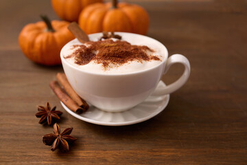 Autumn Latte Delight. A cozy spiced latte with cinnamon on a wooden table