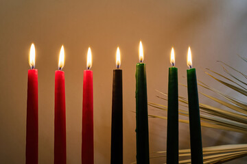 Kwanzaa Candles. Lit Kwanzaa candles in red, black, and green symbolize unity and celebration.