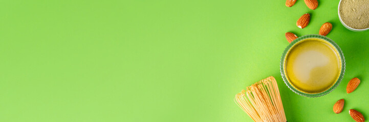 Matcha powder protein drink, vegan matcha tea protein whey shake cocktail, with almond.Healthy vegetarian superfood, trendy diet beverage, with protein powder in scoop, on white green background