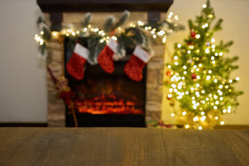 Cozy Holiday Fireplace. Festive fireplace with stockings, garland, and a lit Christmas tree