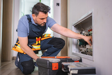 Fototapeta premium Plumber fixing pipes and valves of heating system in a residential building