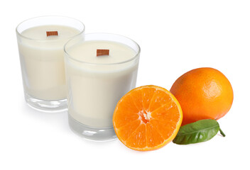 Citrus scented candles and fresh tangerines isolated on white