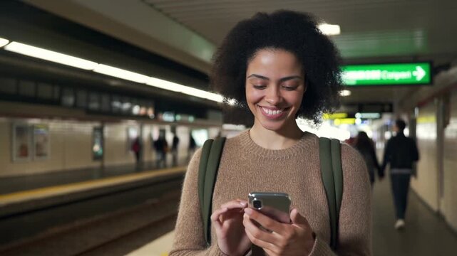 A woman looking at the phone on subway station, smiling  Stock Video