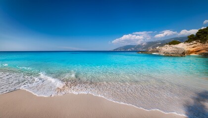 an image of a sandy beach with clear blue water perfect for serene and tranquil vacation destinations idyllic coastline