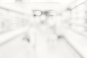Soft bright defocused view of supermarket aisle with glowing white blur creating minimal abstract...