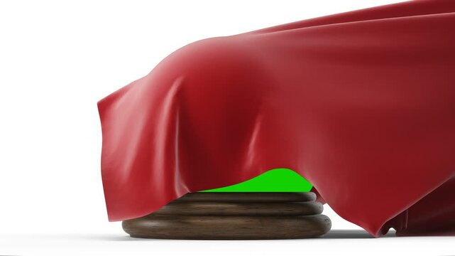 Unveiling a glass orb on a wooden base covered by a red cloth on a white background. A red cloth is being pulled back to reveal a glass orb. Isolated with green chroma key and luma matte