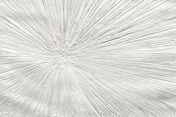 Obraz premium Abstract radial textured surface with rough plaster lines, monochrome decorative pattern, white stucco background with sunburst effect and geometric linear relief