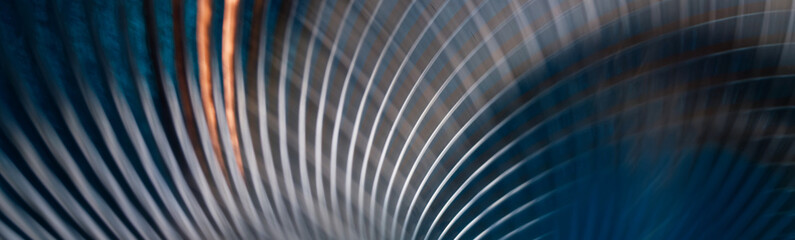 Abstract panoramic background with curved metallic lines on a dark blue backdrop. Futuristic web banner design with motion blur effect. Photo