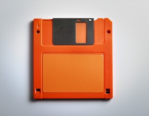 old orange diskette on a white background