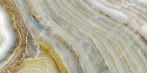 Close-up of a polished natural stone surface with elegant wavy patterns and subtle color variations.