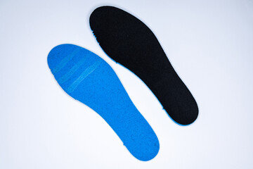 Shoe inserts on a white background. Comfortable orthopedic shoe accessories. Photo taken with flash.