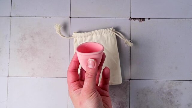 Menstrual cup. Pink feminine hygiene product. Women health concept. 
