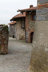 A narrow "rua" (cobblestone street) inside the Ricetto di Candelo, a fortified medieval village in Piedmont. 