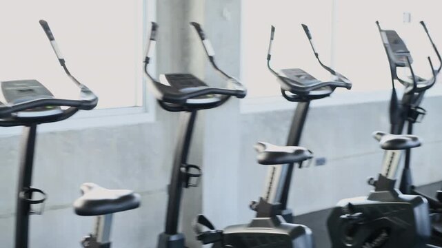 Fitness concept of 4k Resolution. A wide variety of exercise machines are neatly arranged throughout the fully equipped gym.