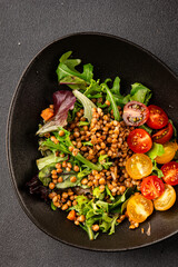 Lentil salad vegetables, tomato, green leaf lettuce tasty snack fresh delicious gourmet food table setting rustic top view copy space keto and paleo diet vegetarian and vegan food