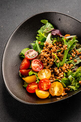 Lentil salad vegetables, tomato, green leaf lettuce tasty snack fresh delicious gourmet food table setting rustic top view copy space keto and paleo diet vegetarian and vegan food