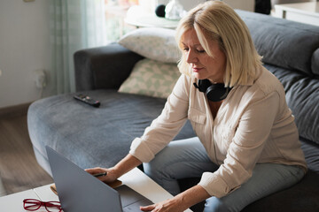 Mature woman working from home using laptop