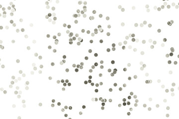 Sparkling silver confetti dots scattered on a clean white surface, creating a festive abstract...