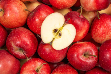 A group of red gala apples viewed from above with a slice cut into the center