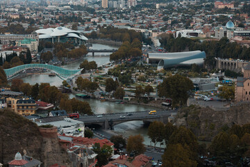 Aerial View Of Tbilisi Cityscape With Peace Bridge And Mtkvari River