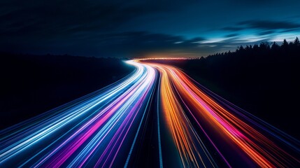 Stunning long exposure shows vibrant light trails on highway at night, perfect for transportation, technology, or futuristic concepts and designs