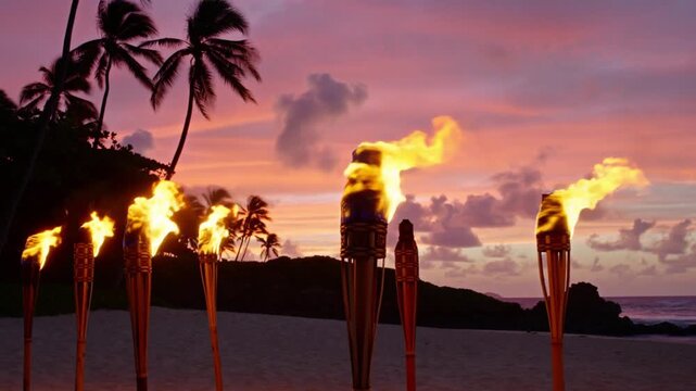 Fiery tiki torches illuminate a tropical beach at sunset, creating a warm, inviting atmosphere. The scene evokes a sense of peace and tranquility Stock Video