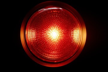 Circular red-orange glow emanating from a safety fire alarm indicator with calm pulse