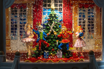 Closeup of Christmas Globe with  Nutcracker figures in winter snow