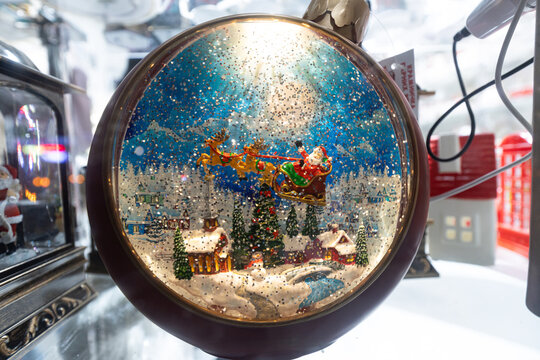 Santa Claus sleigh in Christmas snow globe